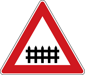 Level crossing with barriers ahead sign in Czech Republic