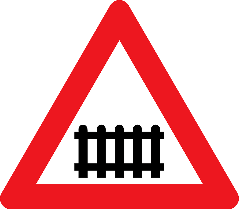 Level crossing with barriers ahead sign in Denmark