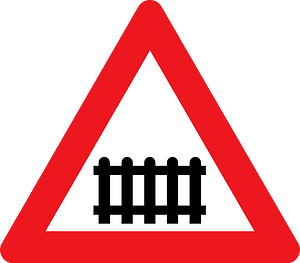 Level crossing with barriers ahead sign in Denmark