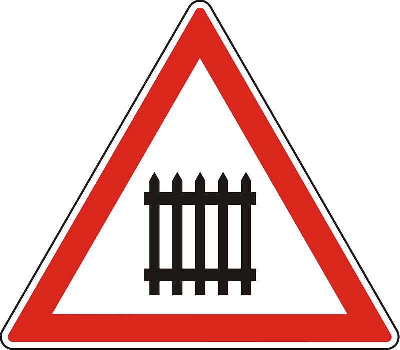 Level crossing with barriers ahead sign in Hungary