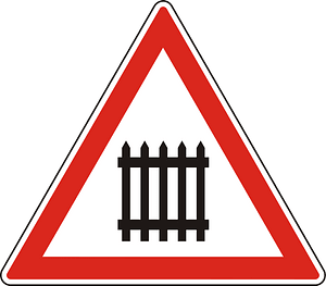 Level crossing with barriers ahead sign in Hungary
