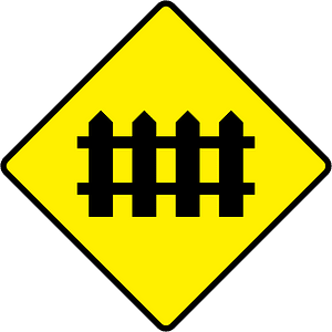 Level crossing with barriers ahead sign in Ireland