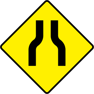 Road narrows ahead sign in Ireland