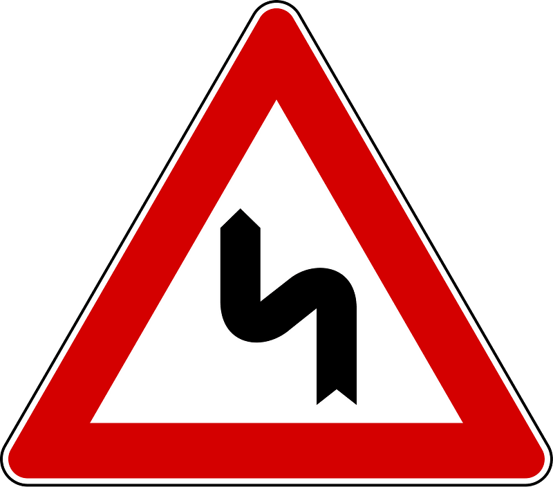 Double bend ahead sign in Italy