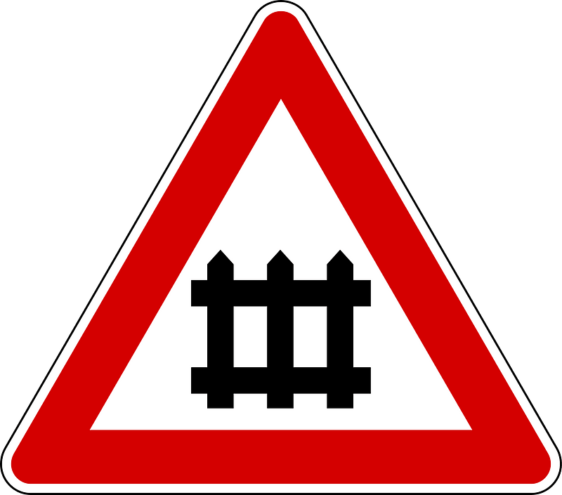 Level crossing with barriers ahead sign in Italy
