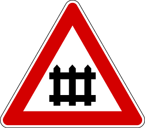 Level crossing with barriers ahead sign in Italy