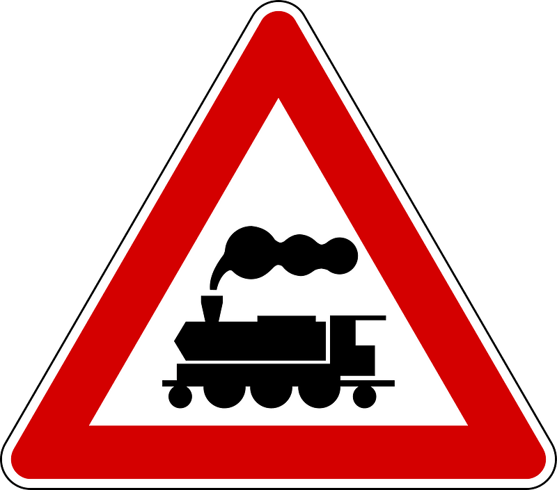Level crossing without barriers ahead sign in Italy