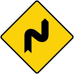 Double sharp curve ahead sign in Liberia