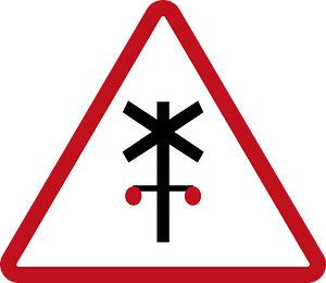 Level railroad crossing with barriers ahead sign in Philippines