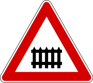 Level crossing with barriers ahead sign in Slovenia