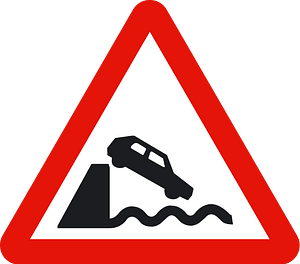 Unprotected quayside or riverbank sign in Spain