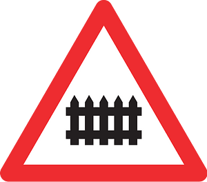 Level crossing with barriers ahead sign in Switzerland