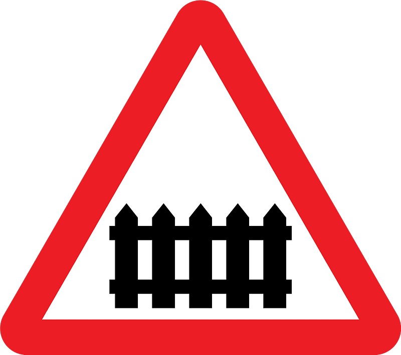 Level crossing with barriers ahead sign in UK