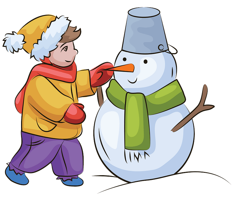 Boy building snowman