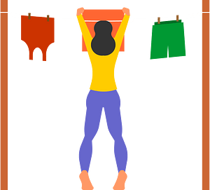 Woman hangs up washed laundry