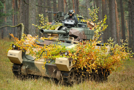 Soldier commands a tank in combat photo