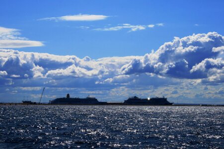 Luxury yachts glitening water clouds