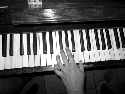 Hand playing keyboard keys photo