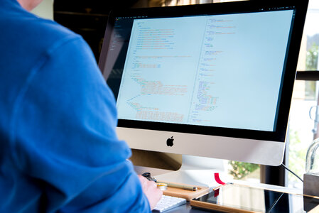 Programmer Working Writing Code at His iMac photo