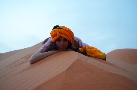 Woman in a Turban Is Lying on the Sand Dune photo