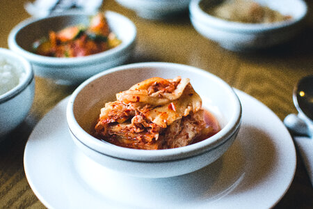 Kimchi in a white bowl close up photo