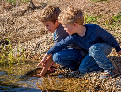 Two boys release fish