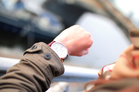 Woman on the street looking at her watches photo