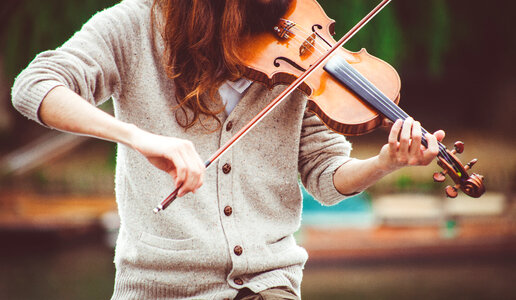Woman Wearing Beige Sweater Playing Violin photo
