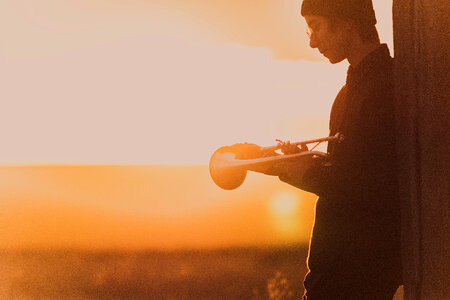 Young Man with Trumpet at Sunset photo