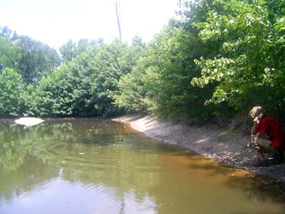 Boy pond stick photo