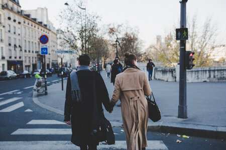 Young Couple Holding Hands Walking the Streets photo
