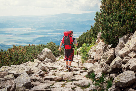Traveler Man with backpack. Mountains landscape on background. photo