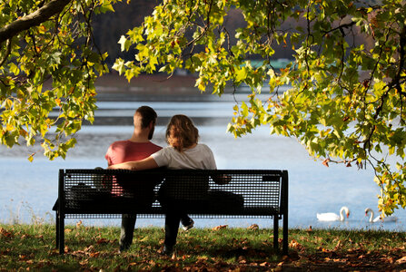 Couple sitting on the park bench photo