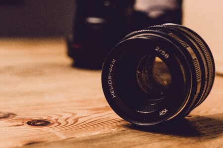 Camera Lens on Wooden Table photo