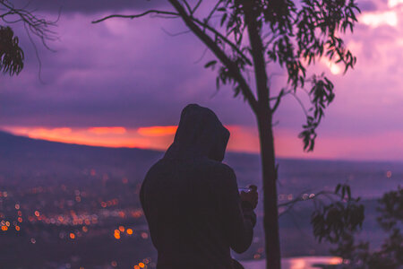 Sunset at the Mountain View with a Man Wearing Hood photo