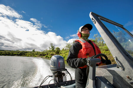 Biologist pilots boat on the Andreafsky River