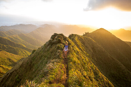 Woman Running in Mountains at Sunset photo