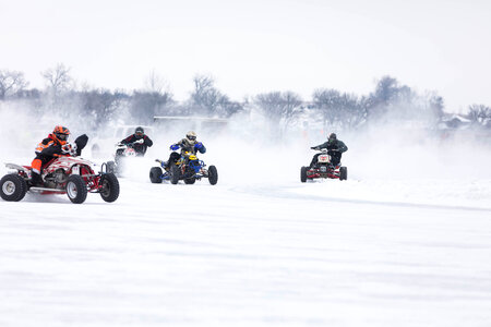 Extreme winter sports, boys driving quad vehicle at winter.