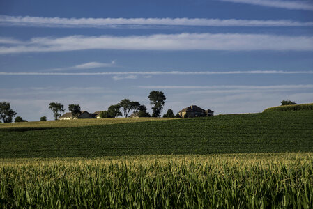 Streaks of clouds over the houses and farm