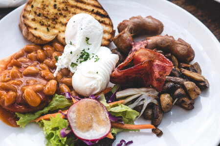 High protein brunch with poached eggs, beans and bacon photo