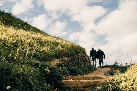 Men Hiking Grassy Hills photo