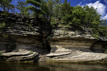 Cave in the Rocks with trees on top photo