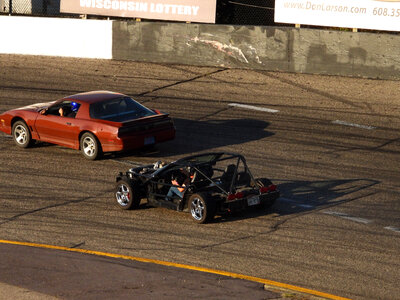 Two cars racing around the track