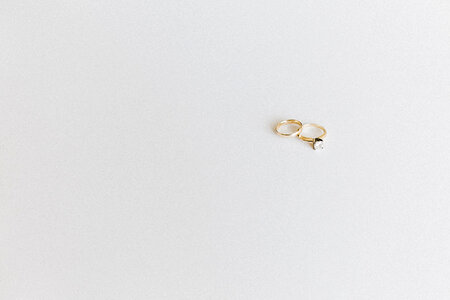 Wedding and Engagement Gold Rings against White Background photo