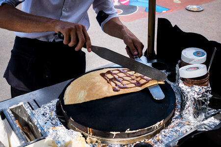 Man making pancakes on the street photo