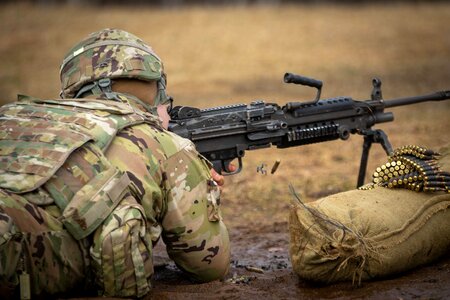 Soldier with a machine gun is training in shooting