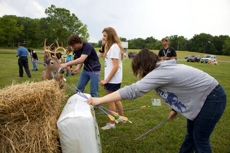 Youth removes an arrow from her target