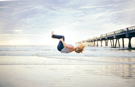 Woman Jumping Beach Sunset photo