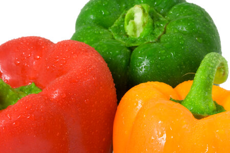 Red green and yellow peppers with water drops photo