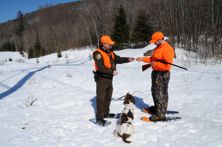 Service Law Enforcement Officer spot checks a hunter-2 photo